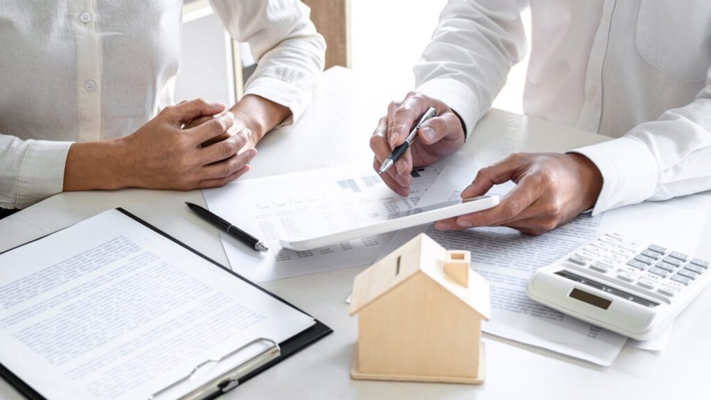 Image showing a loan officer assisting a customer with loan paperwork.