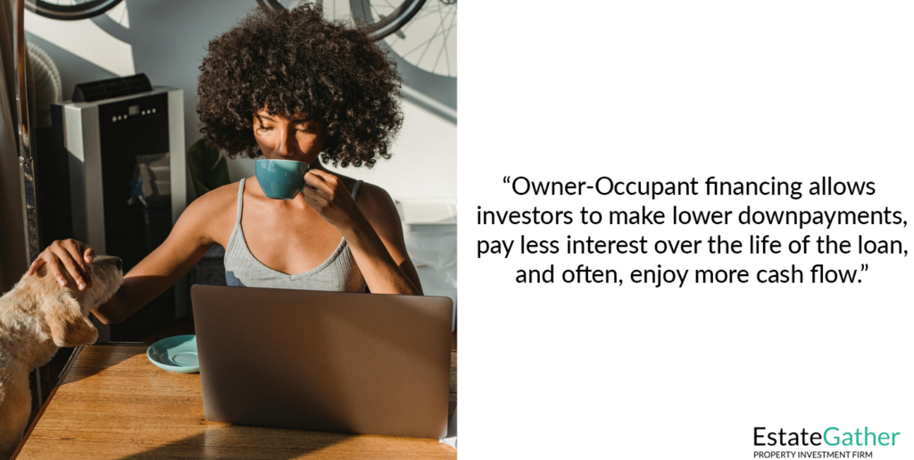 A woman is shown working on her laptop while sipping coffee and her dog watches. Text to the right reads: Owner-Occupant financing allows investors to make lower down payments, pay less interest over the life of the loan, and often, enjoy more cash flow.