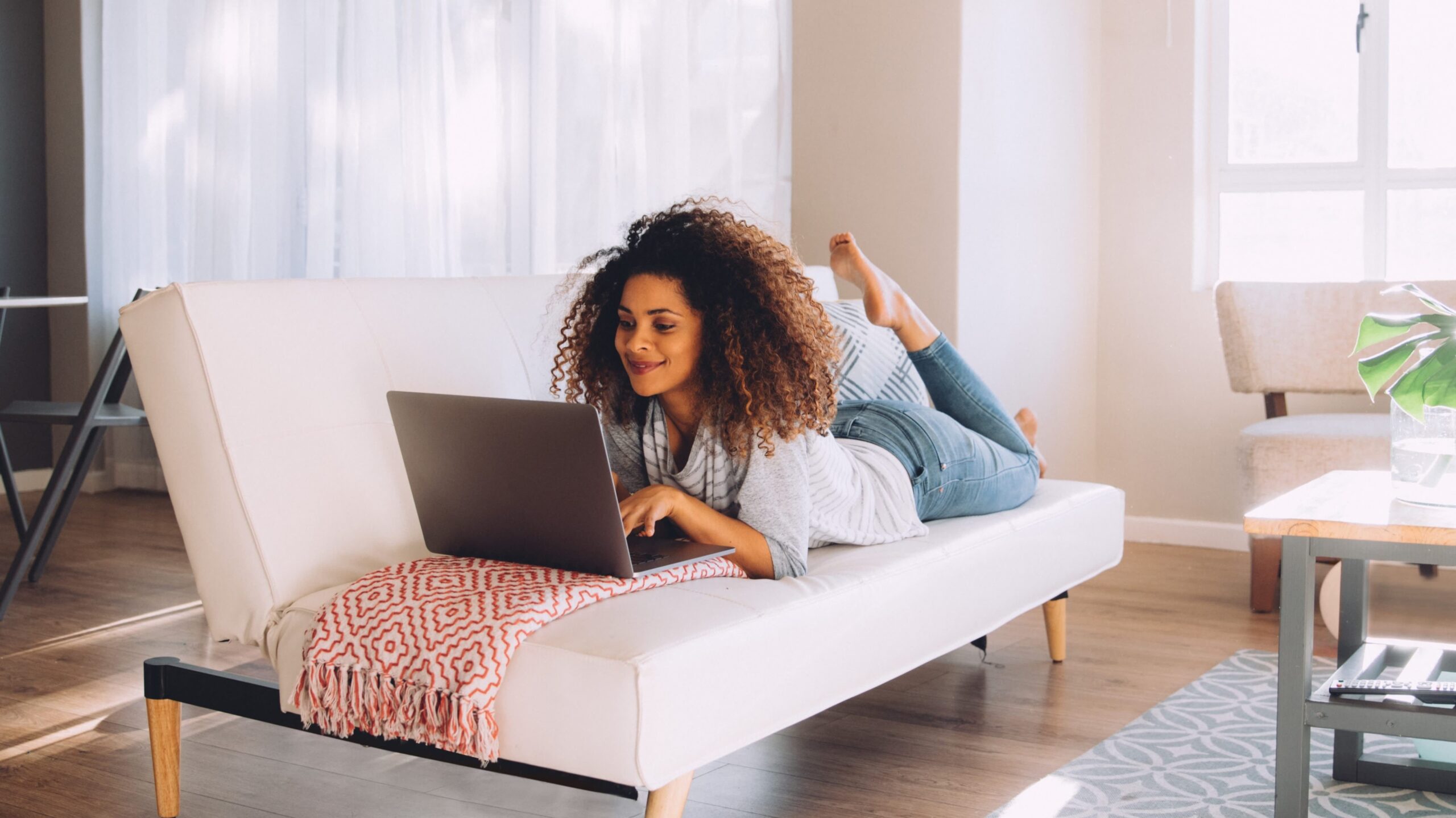 A woman working on her laptop. She is maximizing her returns, using EstateGather's techniques.