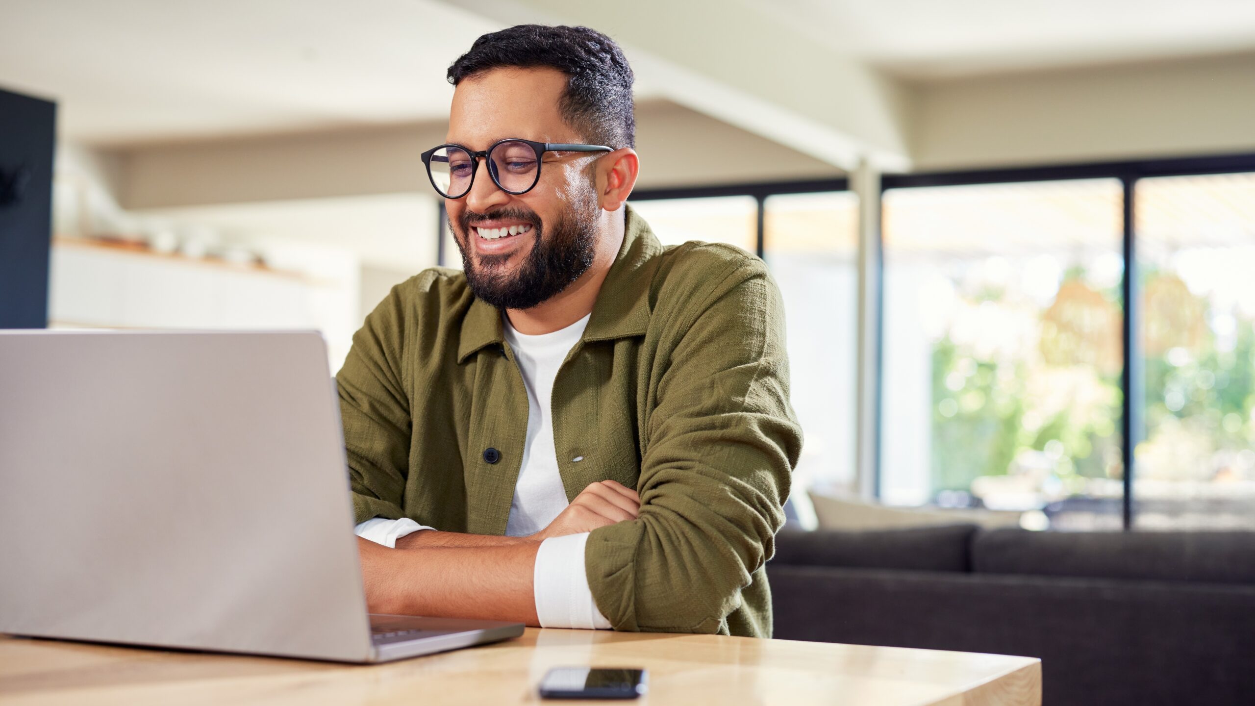 A real estate investor reviews performance metrics on a laptop in a home office—analyzing cash flow and returns with clarity and focus.