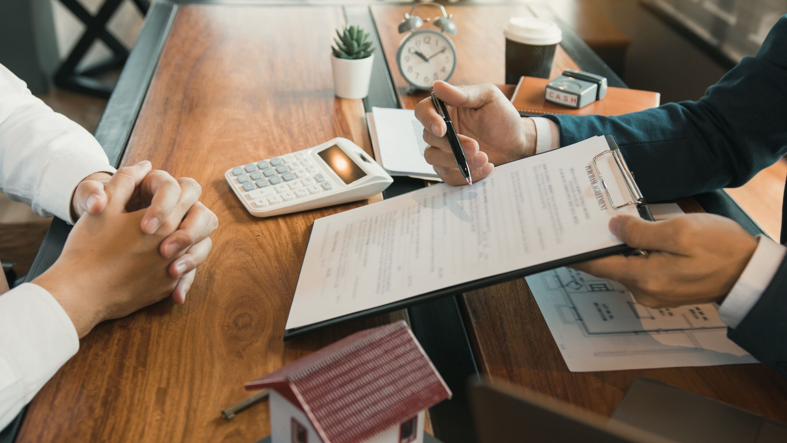 A loan officer reviews a property’s financials during a loan application, ensuring DSCR requirements are met for financing approval.